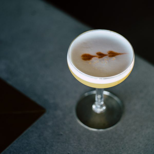 A bird's eye view of a foamy-topped cocktail