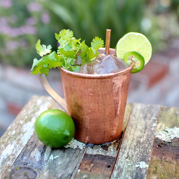 Copper mug overflowing with mint and ice