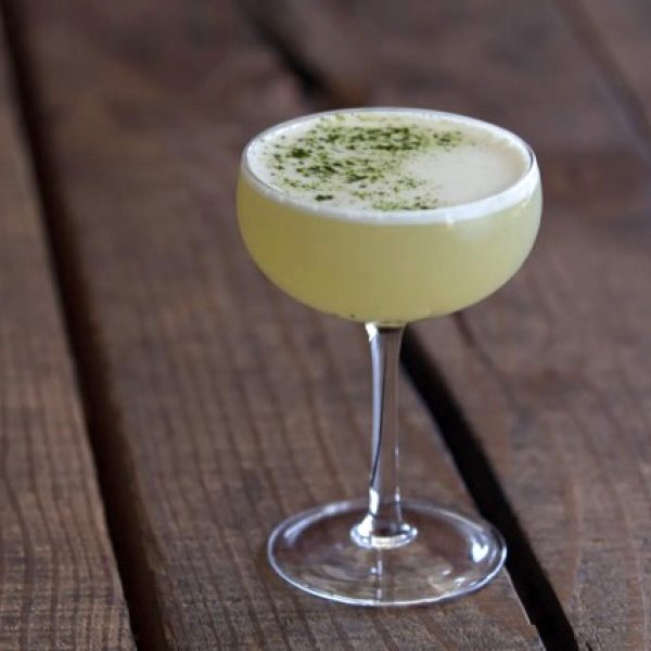 A light green cocktail in a martini glass