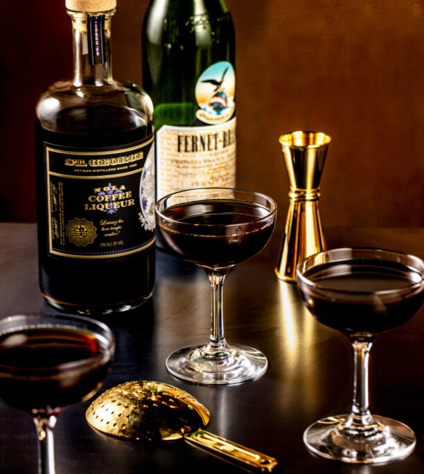 A NOLA bottle, a bottle of Fernet Branca and some cocktail making equipment